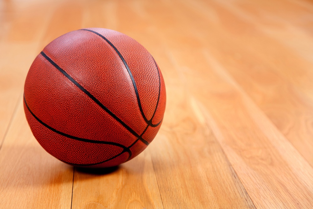 Image of a basketball lying on a wooden floor.jpeg